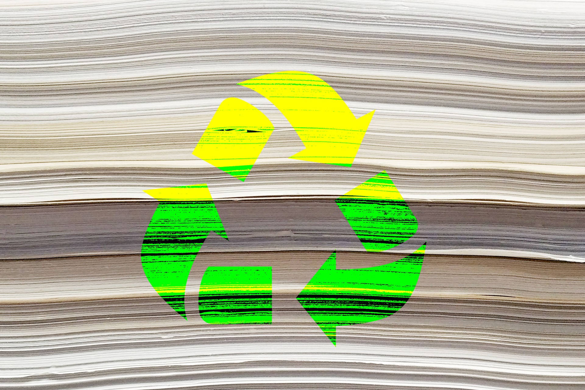 Recycle icon on stack of paper background